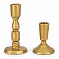 Two textured brass candlesticks on a white background, one tall and one short.