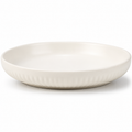 A round ceramic plate with a fluted rim, shown from a side angle on a clean white background.